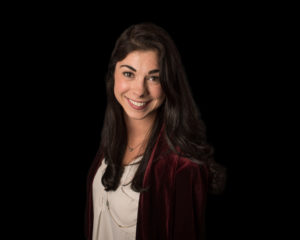 Corporate headshot with black backdrop of female employee in Seattle
