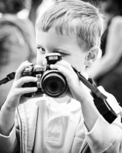 Little boy photographing