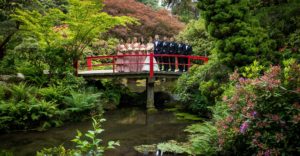 bridesmaids and groomsmen and couple on bridge at kubota garden.