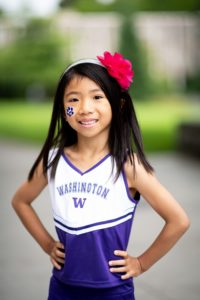 UW husky cheerleader wannabe with hands on hips and a big smile