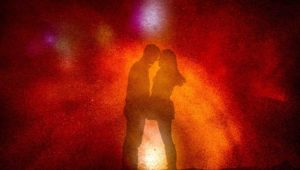 Silhouette of couple facing each other with vibrant colored background