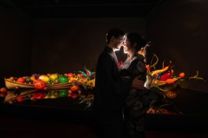 Couple in kimonos in front of Chihuly blown glass art in Seattle.