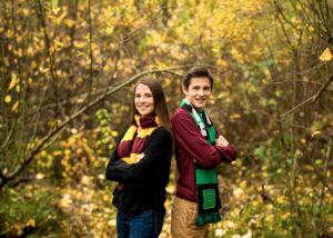 Brother and sister posing for portraits while wearing their school scarves