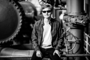 Black and white image of boy with sunglasses looking cool for senior portraits at Gasworks in Seattle
