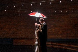 WSU wedding couple with red and white Coug umbrella