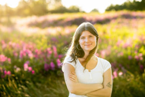 Portrait of woman in field of flowers