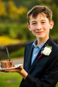 Boy smiling with cake in hand