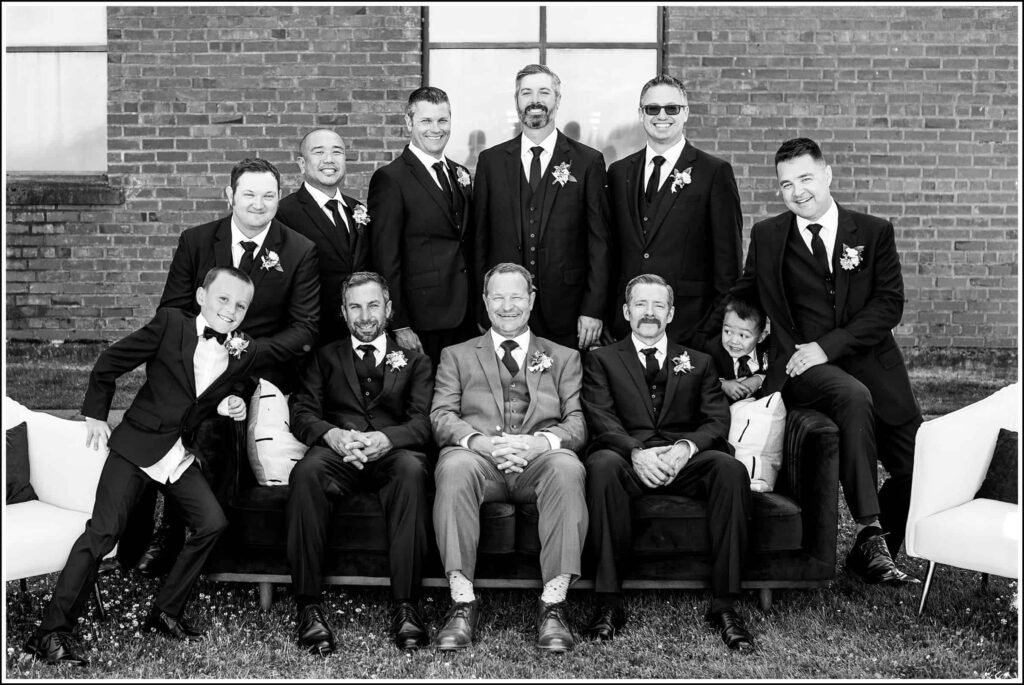 groomsmen in black and white with brick wall in background at semiahmoo resort in blaine, wa
